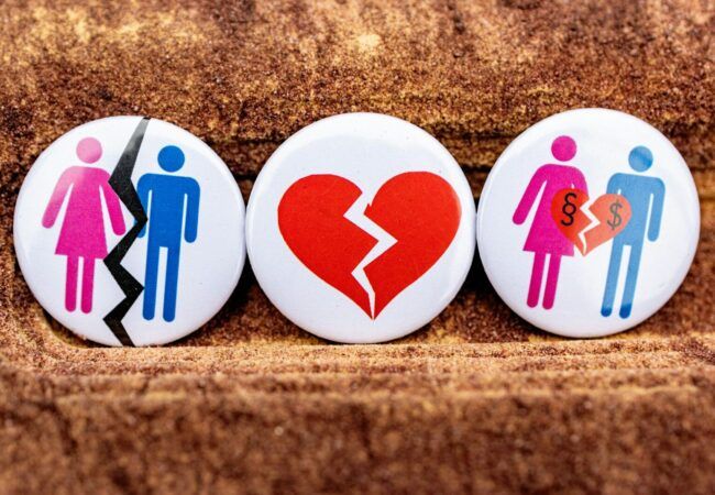three buttons depicting a broken heart, a man and a woman